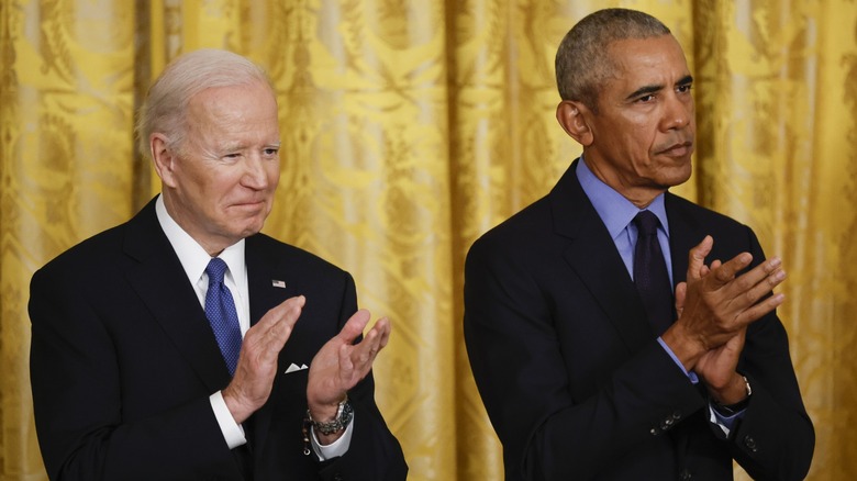 Joe Biden clapping with Barack Obama