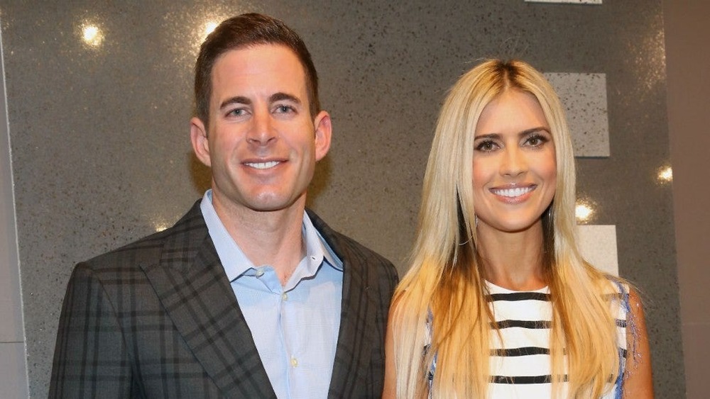  Christina Haack and Tarek El Moussa in front of a gray wall