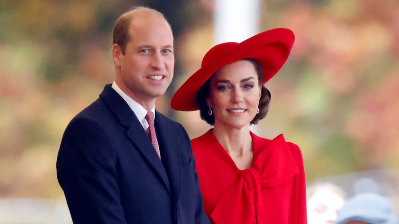 Kate Middleton red dress and hat Prince William blue suit