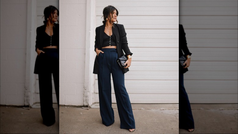 Woman poses in black and blue officewear 