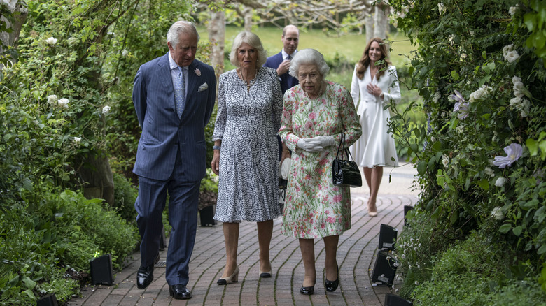 Prince Charles, Camilla and the queen walking with William and Kate in background