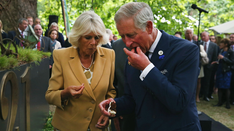 Camilla and Prince Charles eating cake