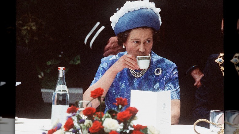 Queen Elizabeth II sips tea 
