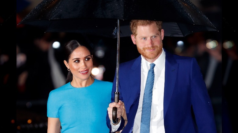 Meghan Markle and Prince Harry under an umbrella