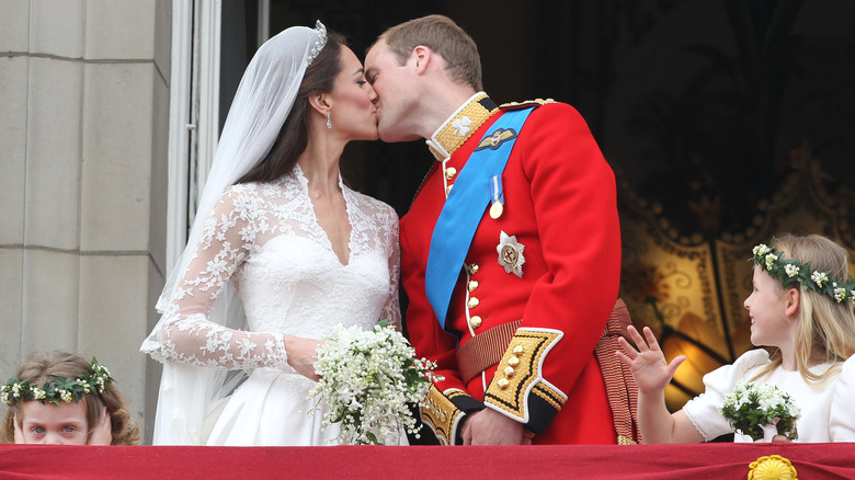 The Duke and Duchess of Cambridge share a kiss on the balcony at Buckingham Palace