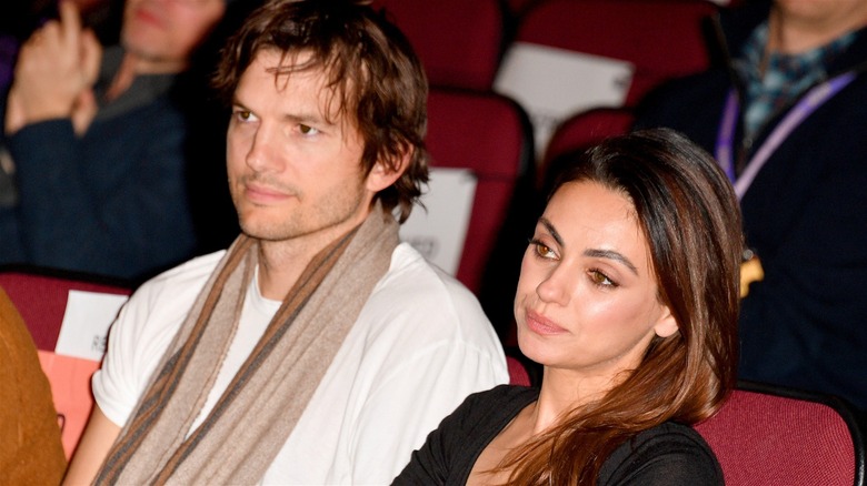 Ashton Kutcher and Mila Kunis sitting in theater