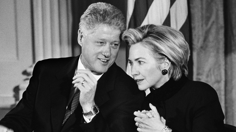 Bill and Hillary Clinton talking discreetly