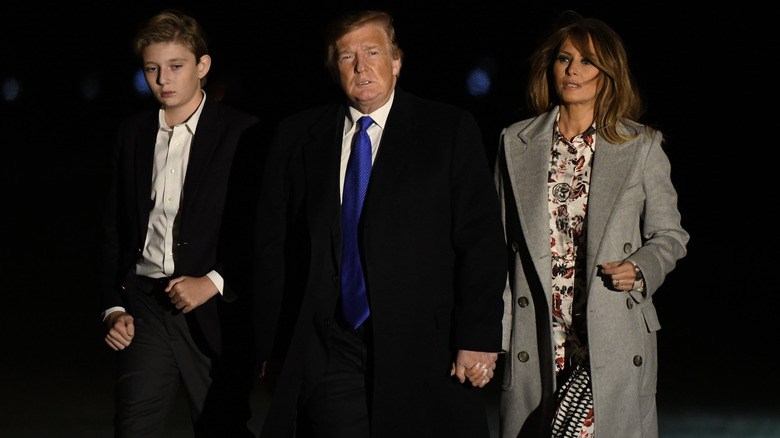 Barron Trump, Donald Trump, and Melania Trump walking