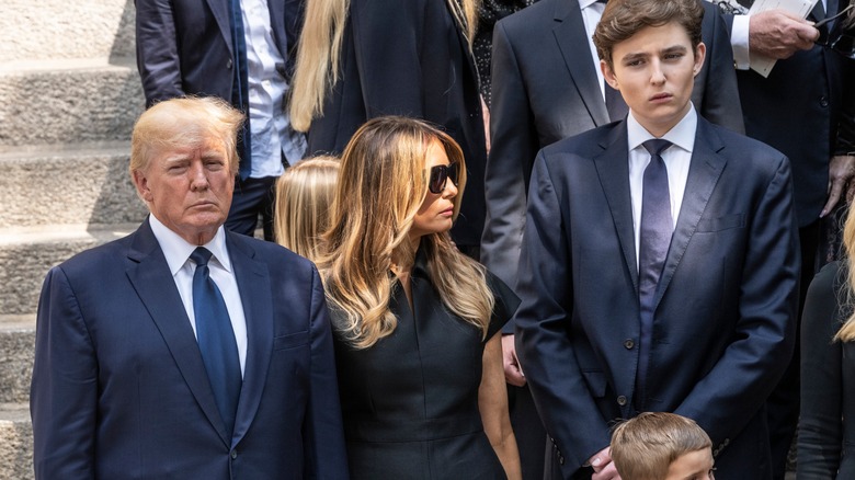 Donald, Melania, and Barron Trump frowning 