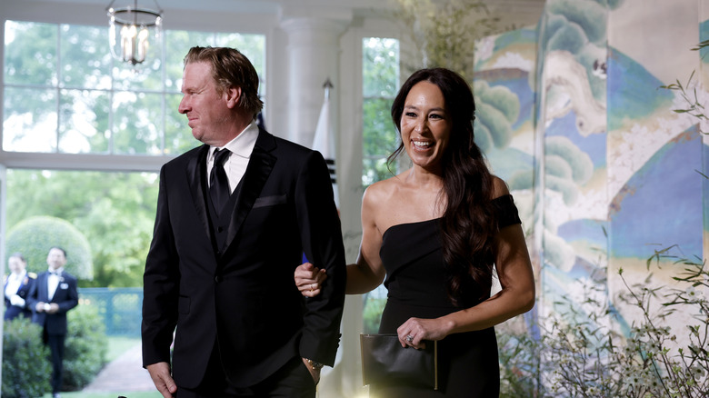 Chip and Joanna Gaines walking together in black tie attire