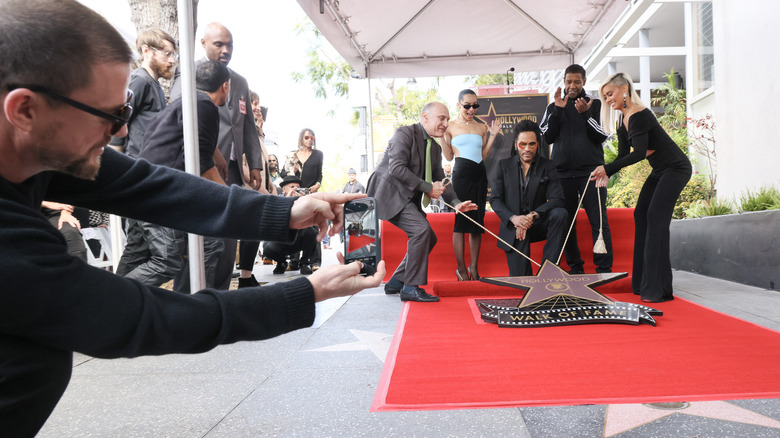 Channing Tatum taking a photo of Lenny Kravitz