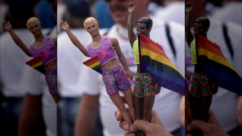 Two Ken dolls posed with Pride flags 