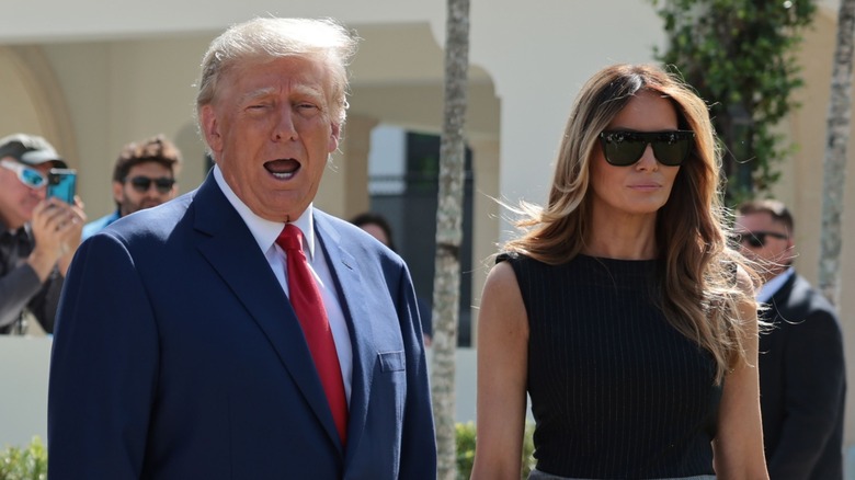 Donald Trump talking and standing next to Melania Trump