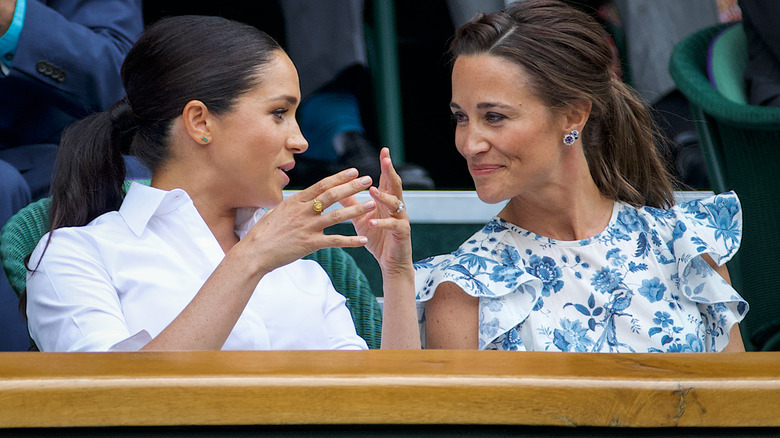 Pippa Middleton talking to Meghan Markle