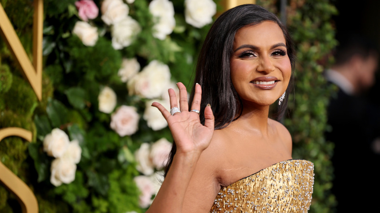 Mindy Kaling smiling and waving