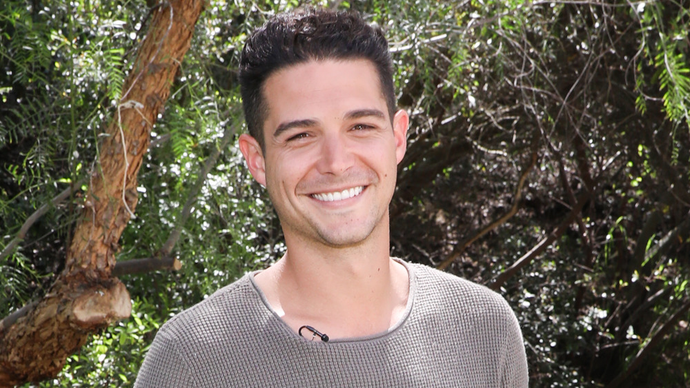 Wells Adams outdoors in tan sweater