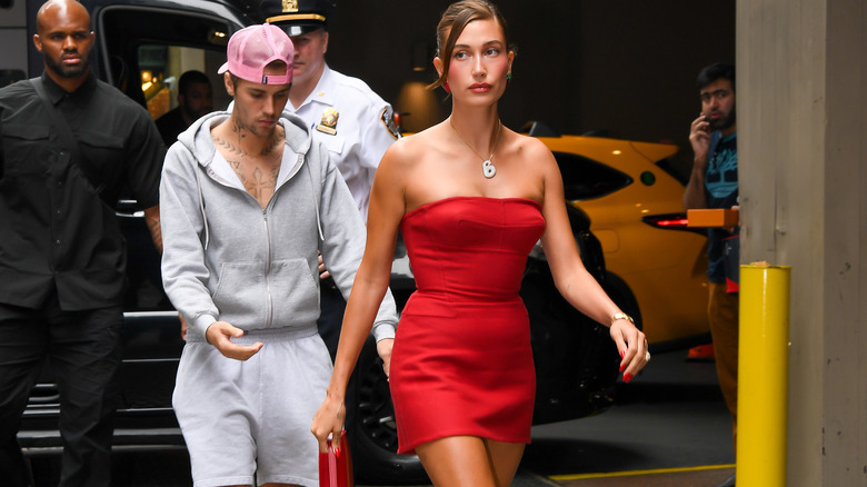 Justin Bieber walking behind Hailey Bieber