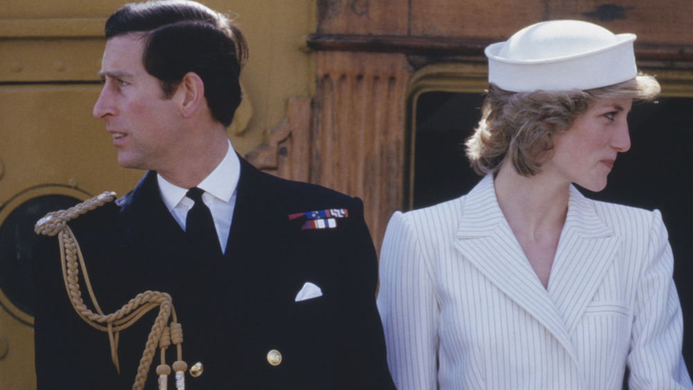 Prince Charles and Princess Diana looking away