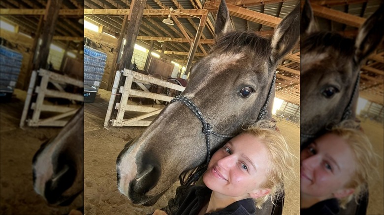 Julia Schlaepfer takes a selfie with a horse