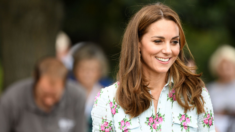 Kate Middleton smiling in flowery blouse