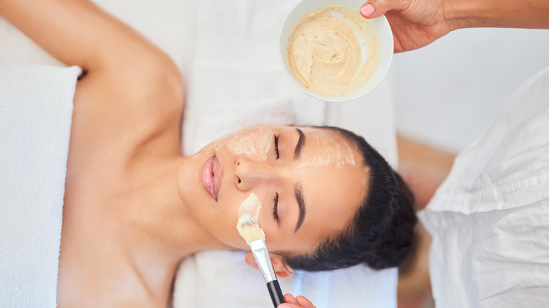 Face mask being applied to woman's face