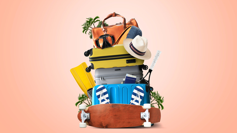 Stacked luggage, a skateboard, a hat and goggles