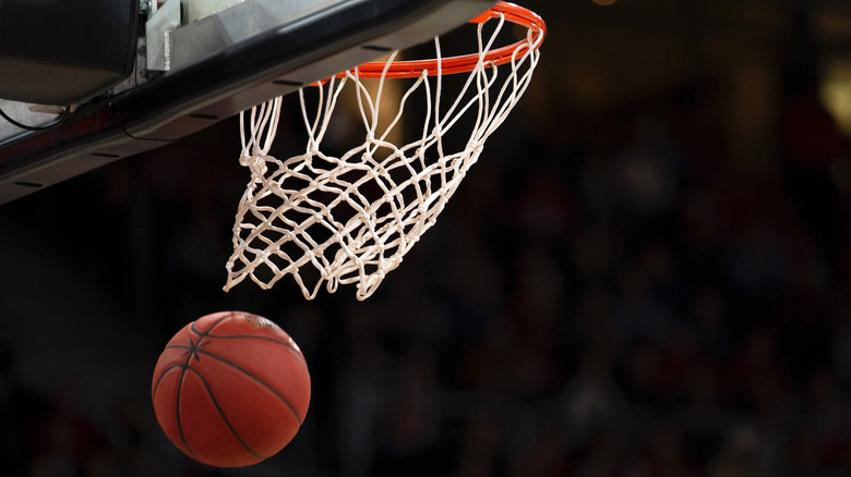 Basketball hoop and basketball mid-air