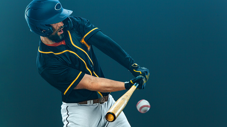 Baseball player swinging at the pitch