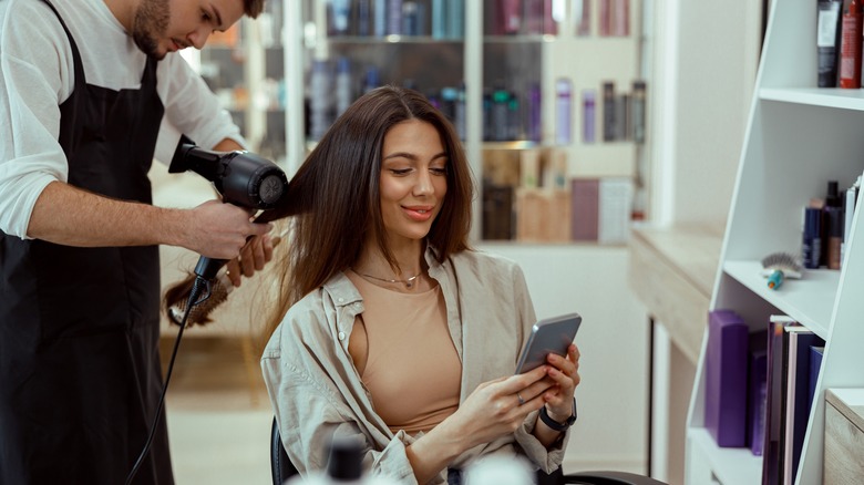 Woman smiles at phone