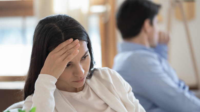 stressed woman sitting next to man