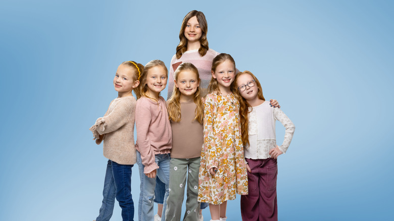 The girls of OutDaughtered against a blue background