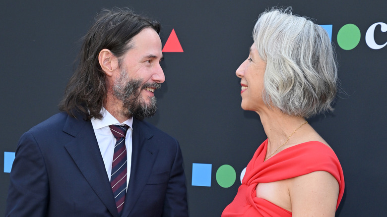 Keanu Reeves smiles at Alexandra Grant