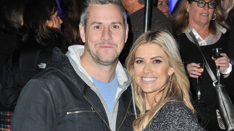 Ant Anstead in a black jacket and Christina Haack in a black and grey jacket at an event outside