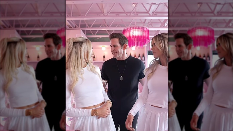 Heather El Moussa and Christina Haack in matching, white tennis outfits and Tarek El Moussa in a black outfit