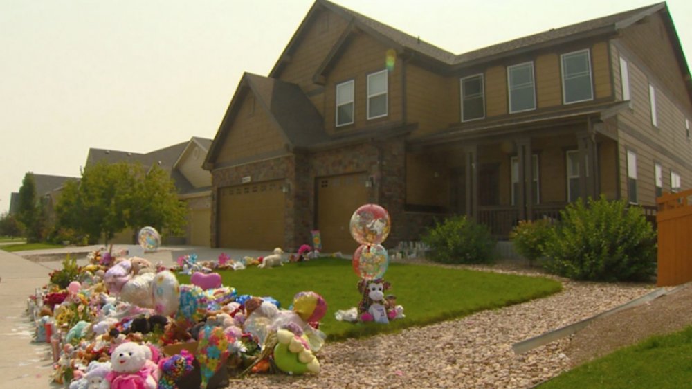 The outside of the Watts' home with a memorial out front, as seen on American Murder: The Family Next Door