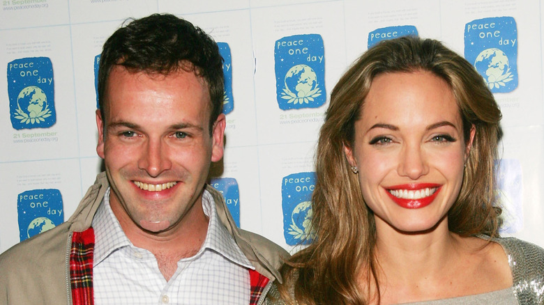 Angelina Jolie and Jonny Lee Miller smiling