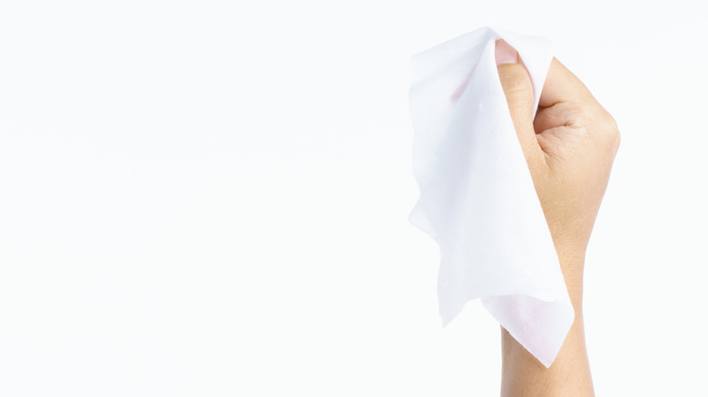 woman holding cleansing wipe