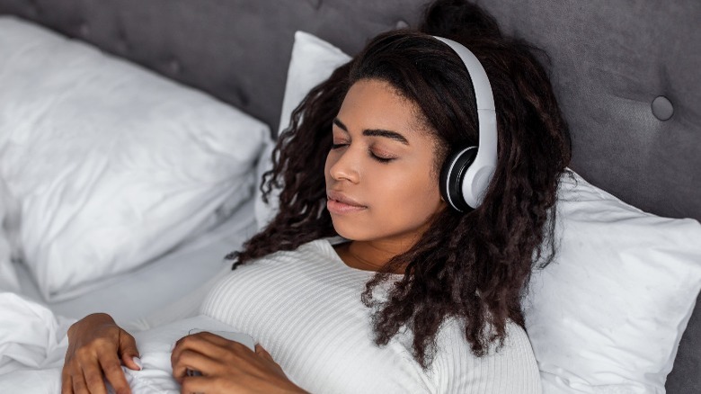 Woman meditates in bed