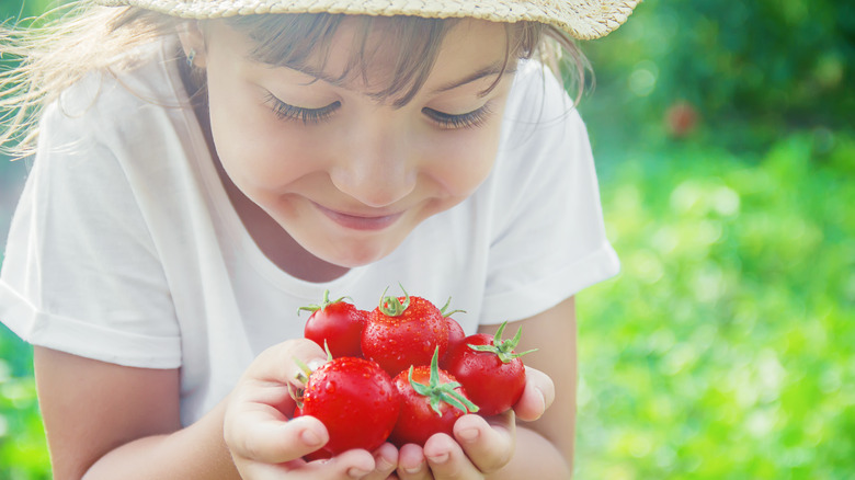 Girl holding tomatoes