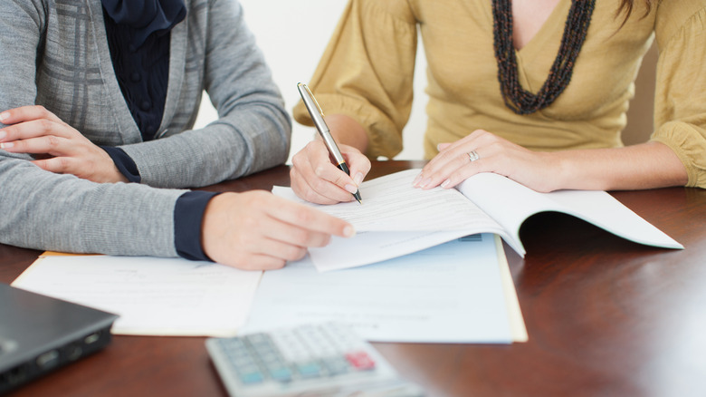 Two women reviewing documents at a desk