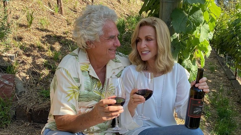 Larry Gilman and Donna Mills drinking wine