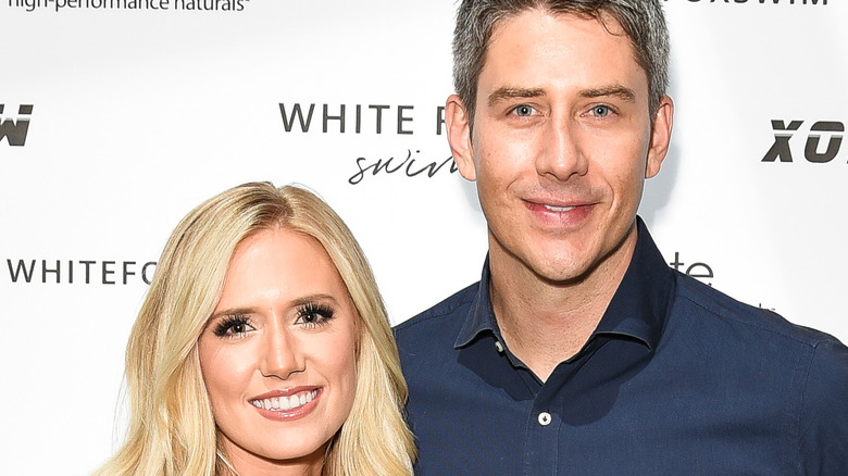 Arie Luyendyk and Lauren Burnham pose at event