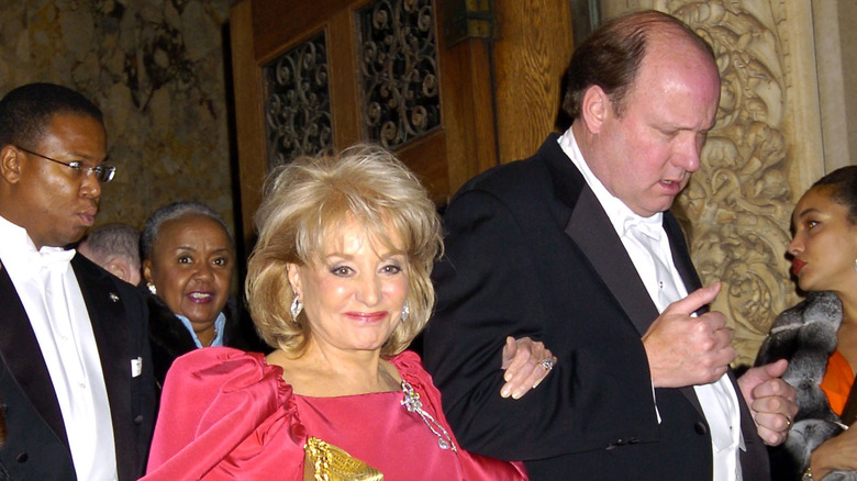 Barbara Walters and Bill Geddie walking arm in arm