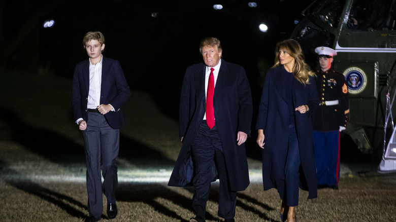 Barron Trump and Donald Trump and Melania Trump exiting Marine One