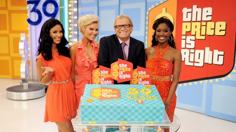 Drew Carey and three Price is Right models