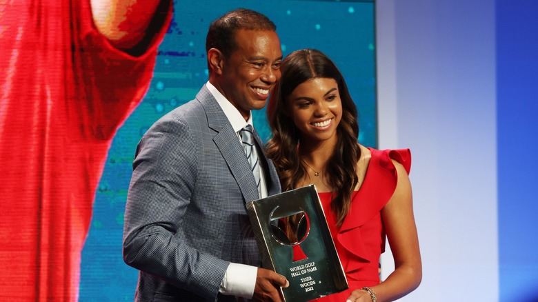 Tiger Woods Sam Woods smiling, holding trophy