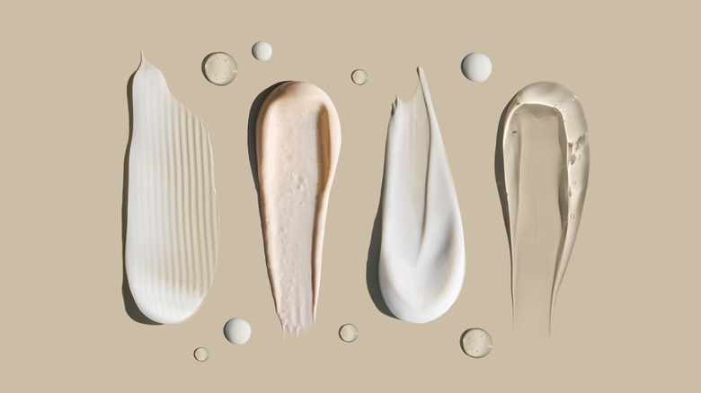 Smears of various skincare products with different textures and colors