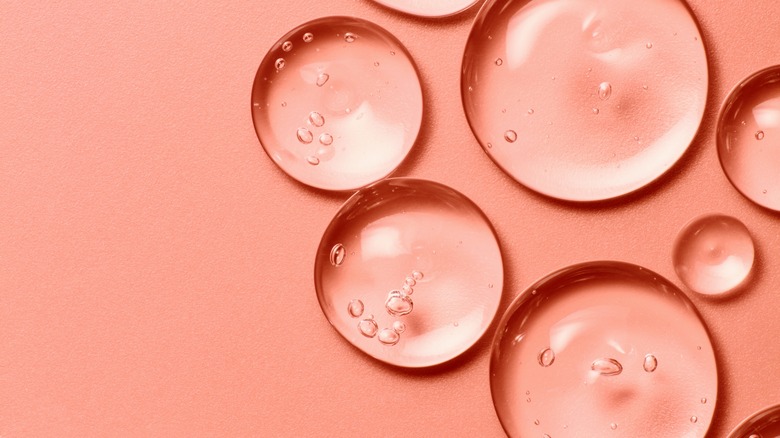 Droplets of clear skincare ingredients