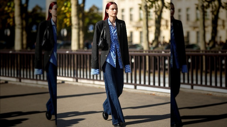 woman sporting flare jeans and blazer