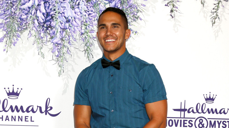 Carlos PenaVega smiling wearing bowtie